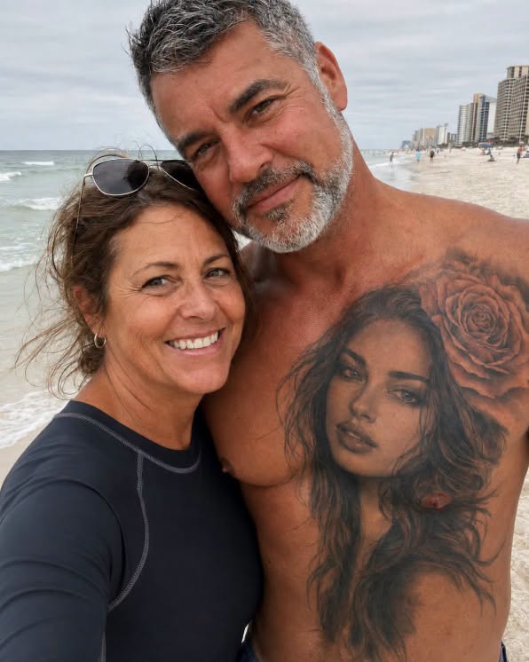 My husband had another woman tattooed over his heart FOR 20 YEARS — he swore she was imaginary until I found her.  I first noticed the tattoo on our honeymoon.  A beautiful young woman stared up from Richard’s chest.  She had dark eyes, delicate features, and a tiny rose tucked behind one ear.  “Who is she?” I asked.  Richard laughed and pulled me closer.  “Nobody, Evelyn. Just a face the tattoo artist invented when I was nineteen.”  I believed him.  For twenty years, I believed him.  I believed him through five failed fertility treatments.  Through every appointment.  Every disappointment.  Every month we told ourselves maybe next time would be different.  And I still believed him the morning we finally brought home our adopted baby girl, Claire.  Over the years, the tattoo became so familiar that eventually I stopped noticing it.  Until last month.  I was searching through Richard’s toolbox for an insurance document when I noticed one of the wooden panels inside the cabinet was loose.  I pulled it back.  Something was hidden underneath.  A yellowed photograph.  The second I saw the woman in it, my entire body went cold.  I recognized those eyes immediately.  I had been looking at them on my husband’s chest for two decades.  And behind her ear was the same tiny rose.  Exactly the same.  My hands started shaking.  Then I noticed what she was holding.  A newborn baby.  Wrapped in a blanket.  Not just any blanket.  Claire’s coming-home blanket.  The one we had wrapped around our daughter the day we brought her home.  I flipped the photograph over.  Six words were written across the back in Richard’s handwriting.  “Forgive me, Rose. She can’t know.”  My knees hit the garage floor.  For several minutes, I just sat there.  Who was Rose?  Why had Richard lied about her for twenty years?  And why was she holding our daughter?  I searched through everything hidden behind that panel.  Old receipts.  Business cards.  A small address book.  Near the back, I found one name.  Rose.  And beside it, an old phone number.  I called before I could talk myself out of it.  The phone rang four times.  Then an older woman answered.  “Hello?”  My throat tightened.  “Is this Rose?”  Silence.  Then she whispered:  “Richard?”  My stomach twisted.  “Is that really you?”  I gripped the phone harder.  “This isn’t Richard.”  Another long pause.  “It’s his wife.”  I heard her inhale sharply.  Then she started crying.  Deep, broken sobs.  And finally she said:  “YOU FINALLY FOUND ME.”  I couldn’t breathe.  “I thought this day would never come.”  “Who are you?”  She didn’t answer.  “Why do I have a picture of you holding Claire?”  Nothing.  “What did Richard do?”  Rose cried harder.  Then she said:  “I can’t tell you over the phone.”  She gave me the address of a diner in the next town.  “Come alone.”  I didn’t wait for Richard to get home from work.  My hands shook so badly while I was driving that I missed the turn twice.  When I finally reached the diner, Rose was already sitting in the last booth near the window.  Silver hair.  Trembling fingers wrapped around a coffee cup.  But even after all those years, I recognized her immediately.  She was the woman tattooed over my husband’s heart.  I slid into the booth across from her.  “You’re Evelyn,” she said quietly.  “And you’re the woman on my husband’s chest.”  Her face crumpled.  I placed the photograph on the table between us.  “Start talking.”  Rose stared down at it.  Then at me.  Before she could answer, the bell above the diner door rang.  Her eyes suddenly moved past my shoulder.  All the color drained from her face.  I turned around.  Someone was walking directly toward our booth.  And when I saw WHO it was, I nearly fainted.  Because I recognized that face too.  And suddenly, the photograph of Claire in Rose’s arms wasn’t the biggest secret Richard had been hiding from me. Type KEYS and I’ll continue. (I know you’re curious about the next part, so please be patient and read on in the comments below. Thank you for your understanding of the inconvenience. please leave a ‘KEYS’ comment below and give us a “Like ” to get full story )👇 See less